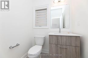 Brampton (Bram West) townhouse for rent - A white toilet sits next to a sink in a small bathroom.
