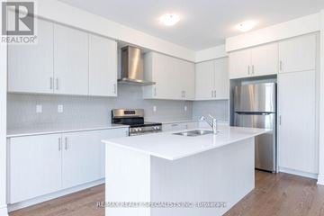 Brampton (Bram West) townhouse for rent - A white kitchen with a sink and stainless steel appliances.
