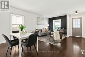 Brantford apartment for rent - A well-lit living room with a dining table and chairs.