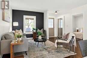 Brantford apartment for rent - A living room with a grey couch, a coffee table, and a rug.