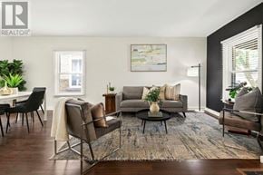 Brantford apartment for rent - A living room with a grey couch, a coffee table, and a painting on the wall.