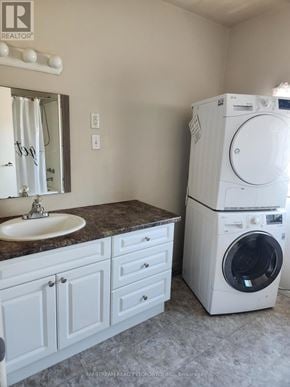 Niagara Falls (Clifton Hill) apartment for rent - A white washer and dryer in a laundry room.