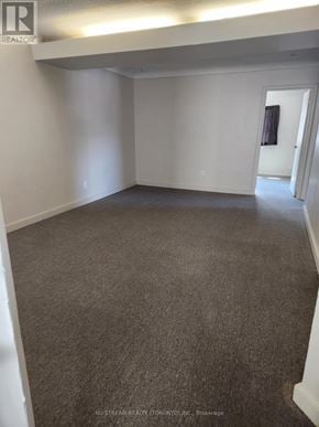 Niagara Falls (Clifton Hill) apartment for rent - A room with carpeted floor and white walls.