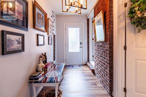Aylmer apartment for rent - A hallway with a brick wall and a white door.