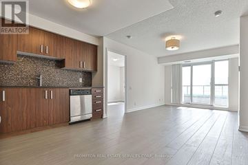Toronto (Willowdale East) condo for rent - A kitchen with wooden cabinets and a stone backsplash is shown.