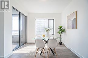 Vaughan (Vaughan Corporate Centre) condo for rent - A dining room with a glass table and chairs.