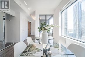 Vaughan (Vaughan Corporate Centre) condo for rent - A modern dining room with a large table and chairs.