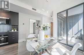 Vaughan (Vaughan Corporate Centre) condo for rent - A modern kitchen with a glass table and white chairs.