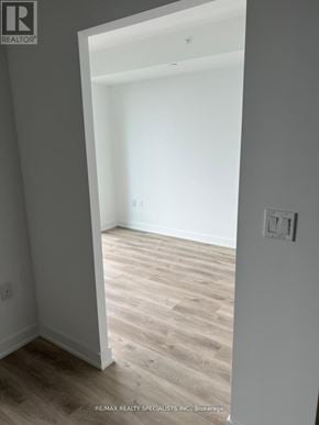 Burlington (Brant) condo for rent - A room with wooden flooring and white walls.