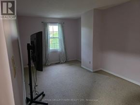 Brampton (Fletcher's Creek South) townhouse for rent - A room with a flat screen TV and a window with curtains.
