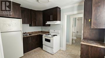 Ottawa fourplex for rent - A kitchen with white appliances and brown cabinets.