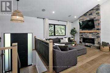 Collingwood apartment for rent - A living room with a grey couch and a fireplace.