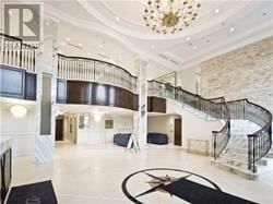 Markham (Unionville) condo for rent - A large, open foyer with a spiral staircase and a chandelier.