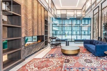Toronto (Mimico) condo for rent - A living room with a large rug and a fireplace.