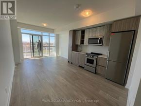 Toronto (Mimico) condo for rent - A spacious kitchen with wooden flooring and stainless steel appliances.