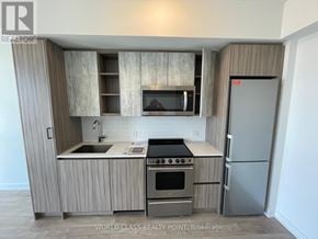 Toronto (Mimico) condo for rent - A kitchen with a refrigerator, oven, and microwave.