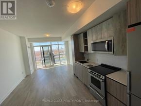 Toronto (Mimico) condo for rent - A well-lit kitchen with a stove top oven and microwave.