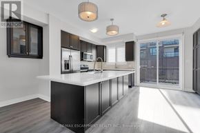 Grimsby (Grimsby Beach) townhouse for rent - A modern kitchen with a large island and stainless steel appliances.