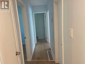 Kitchener apartment for rent - A hallway with a door on the left and a wall on the right.