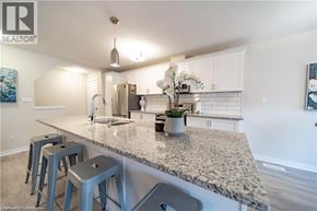 Kitchener townhouse for rent - A kitchen with granite countertops and blue stools.