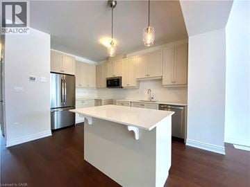 Beamsville townhouse for rent - A kitchen with white cabinets and a white island.