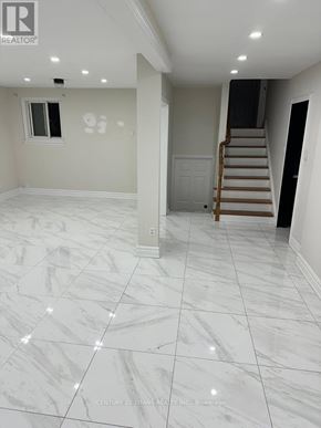 Ajax (South East) apartment for rent - A white marble tiled floor in a room with a staircase.