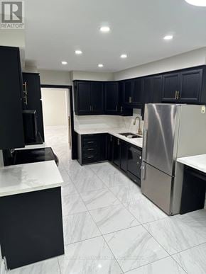 Ajax (South East) apartment for rent - A modern kitchen with black cabinets and a white countertop.