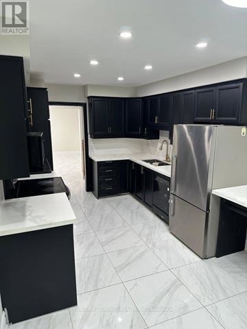Ajax (South East) apartment for rent - A modern kitchen with black cabinets and a white countertop.