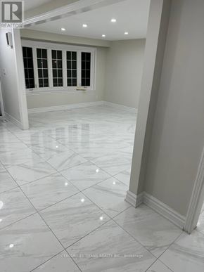 Ajax (South East) apartment for rent - A spacious room with white marble flooring and a window with black bars.