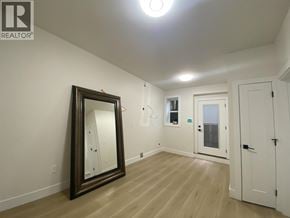 Burnaby apartment for rent - A large mirror is leaning against a wall in a room with wooden floors and white walls.