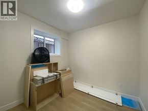 Burnaby apartment for rent - A room with a window and a bed with a black bag on it.