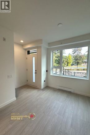 North Vancouver townhouse for rent - A room with a door and a window with a view of a park.
