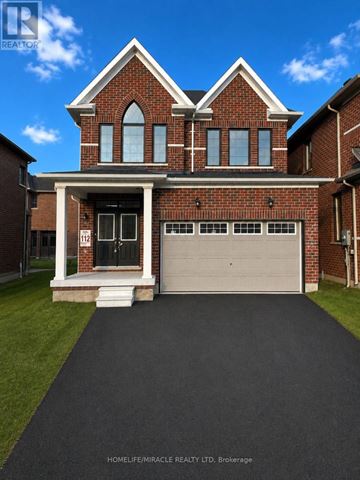 Barrie (Innis-Shore) apartment for rent - A brick house with a garage door and a driveway in front.