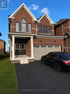 Barrie (Innis-Shore) apartment for rent - A black car is parked in front of a brick house.