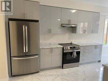 Barrie (Innis-Shore) apartment for rent - A kitchen with a stainless steel refrigerator and a black oven.