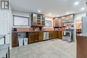 Halton Hills (Rural Halton Hills) apartment for rent - A kitchen with brown cabinets and a tile floor.