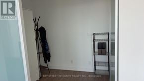 Toronto (Kensington-Chinatown) condo for rent - A room with a coat rack and a shelf.