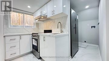 Brampton (Fletcher's Creek South) apartment for rent - A modern kitchen with white cabinets and a black refrigerator.