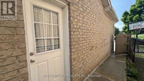 Brampton (Fletcher's Creek South) apartment for rent - A white door with a window is on a brick wall.