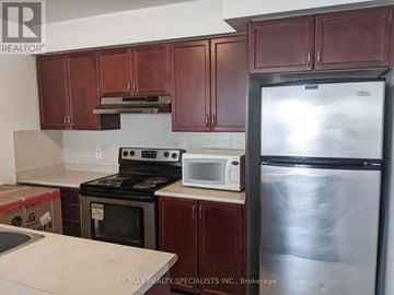 Mississauga (Churchill Meadows) townhouse for rent - A kitchen with brown cabinets and a stainless steel refrigerator.