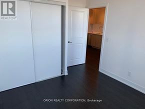 Toronto (Bayview Village) condo for rent - A room with a white door and a white wall with a logo on it.