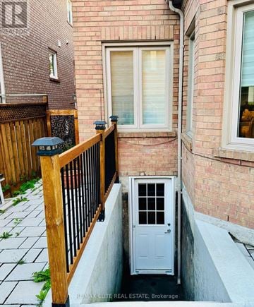 Richmond Hill (Westbrook) apartment for rent - A small white door with a window in the middle is on the side of a building.