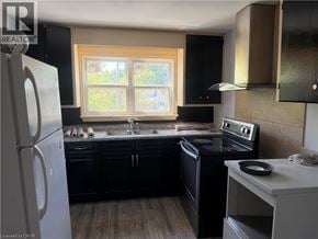 Dunnville apartment for rent - A kitchen with black cabinets and a white refrigerator.