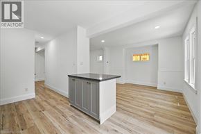 Hamilton apartment for rent - A spacious kitchen with a wooden floor and white walls.