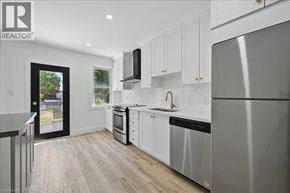 Hamilton apartment for rent - A modern kitchen with white cabinets and stainless steel appliances.