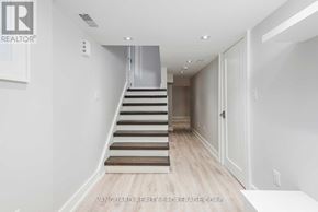 Toronto (Bedford Park-Nortown) apartment for rent - A staircase with a metal railing and wooden steps leads to a second floor.