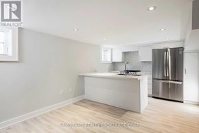 Toronto (Bedford Park-Nortown) apartment for rent - A modern kitchen with stainless steel appliances and white cabinetry.