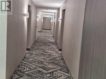 Toronto (Dorset Park) condo for rent - A long hallway with a carpeted floor and doors on both sides.