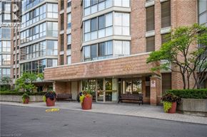 Waterloo condo for rent - The building in the image is a modern apartment complex with a brick facade and large windows.
