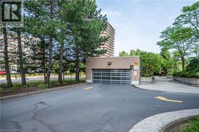Waterloo condo for rent - A parking lot with a building in the background and a yellow arrow on the pavement.